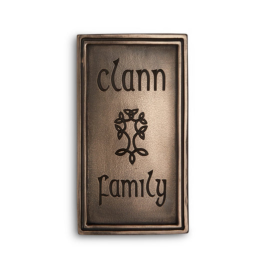 Bronze plaque with "clann" engraved on the top, "family" engraved on the bottom, and a tree engraved in the middle