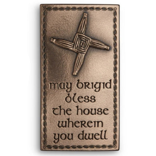 A bronze plaque with an embossed St. Brigid's cross and the engraved words "May Brigid bless the house wherein you dwell."