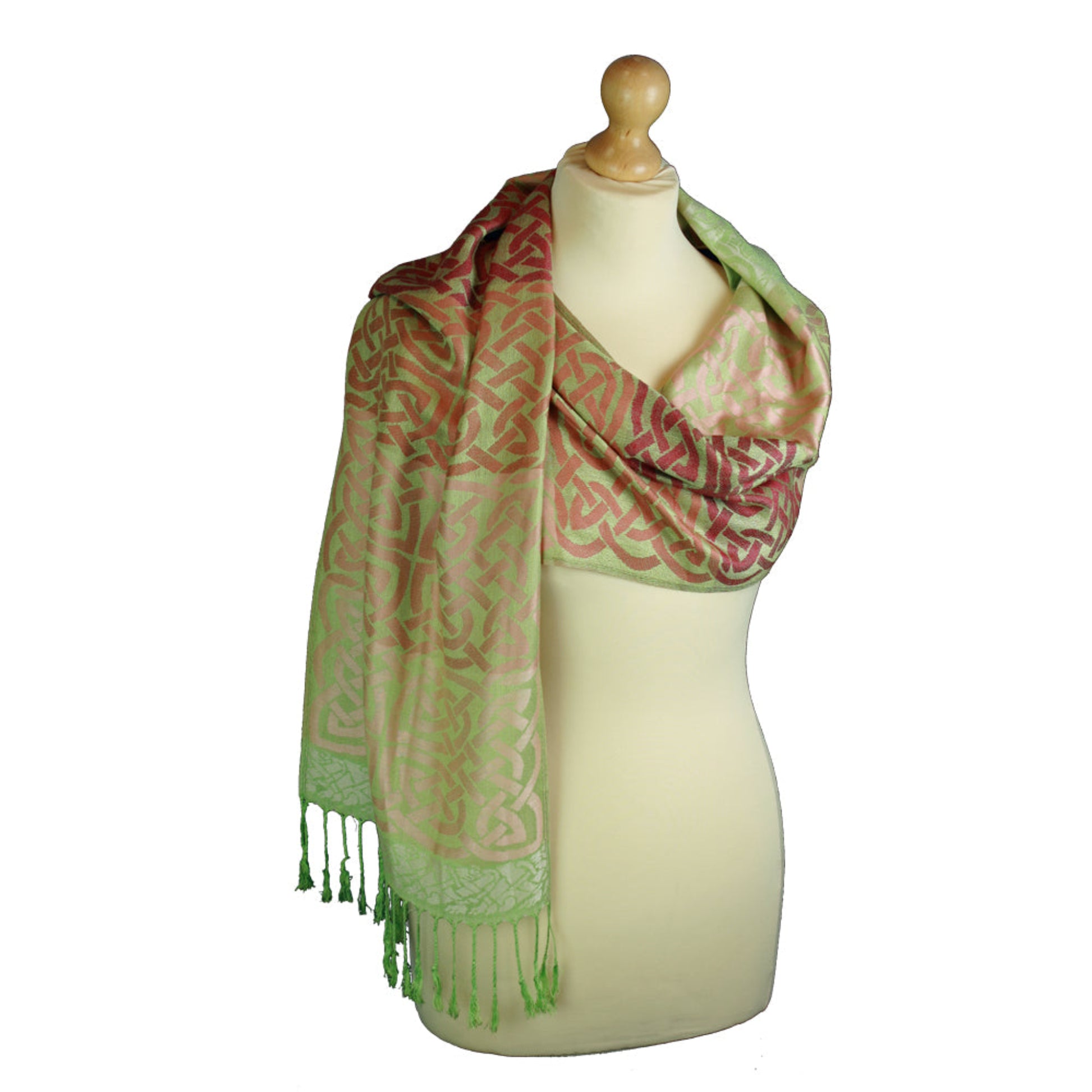 Green and red patterned scarf on a mannequin with a white background