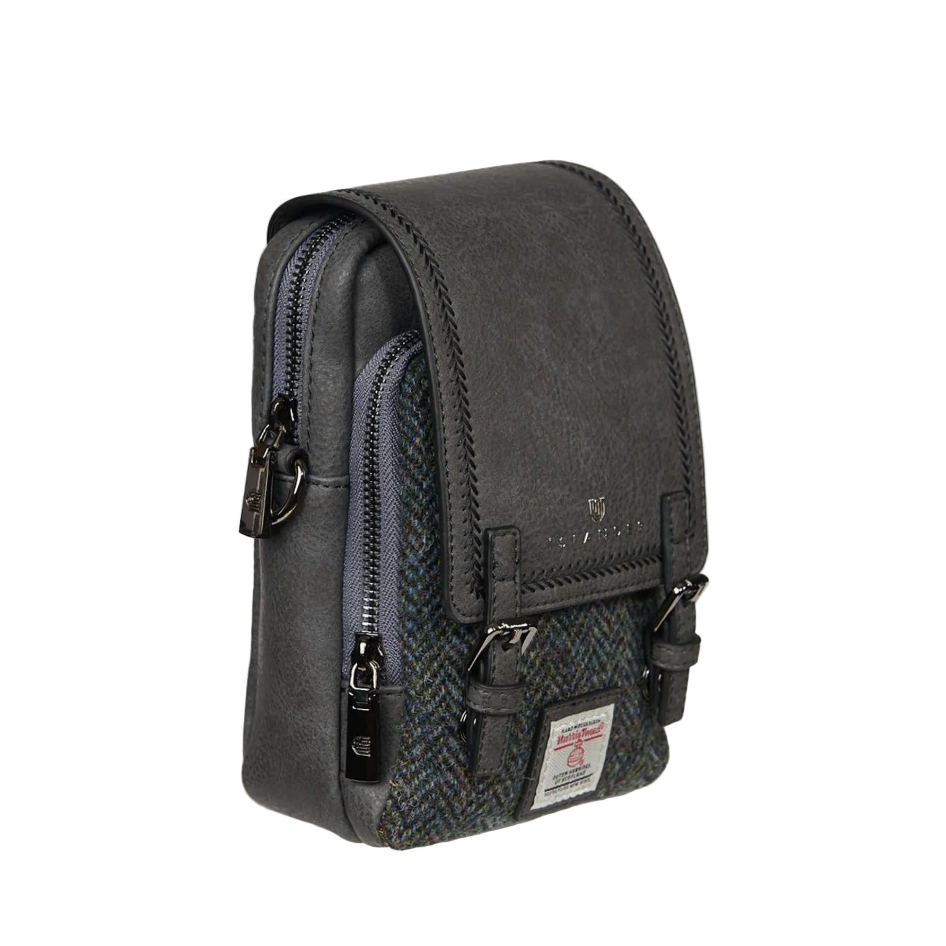 A green Baby Jura Crossbody bag made with Harris Tweed and vegan leather, featuring multiple pockets and a detachable strap.