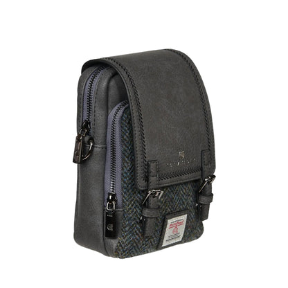 A green Baby Jura Crossbody bag made with Harris Tweed and vegan leather, featuring multiple pockets and a detachable strap.