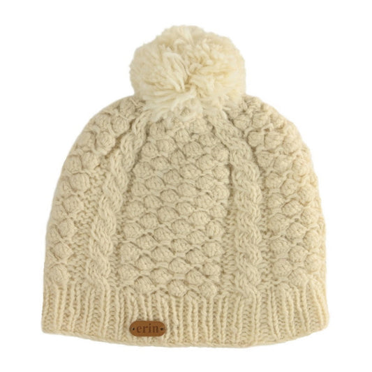 Oatmeal knitted beanie with pom-pom on a white background
