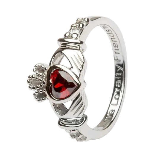 A Claddagh birthstone ring with a heart-shaped garnet stone in the center, sterling silver hands, and round-cut cubic zirconia stones on the band.