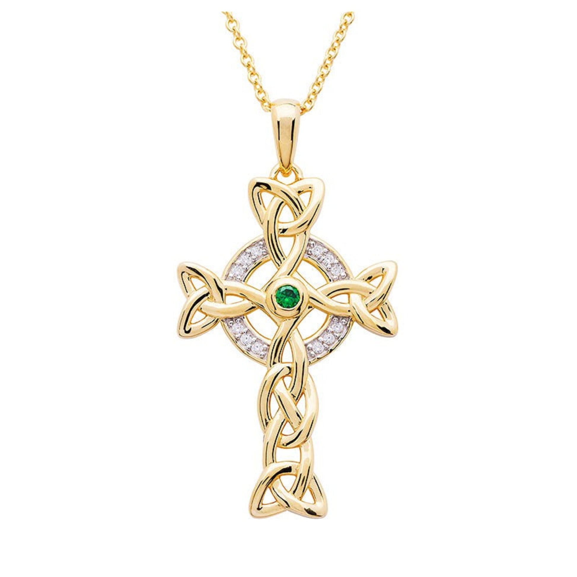 A gold Celtic cross necklace with white cubic zirconias and a central green emerald stone on a chain.