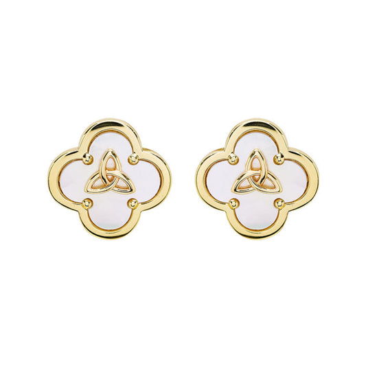 A pair of gold-toned four-leaf clover stud earrings with white inlay and a central gold triquetra symbol, shown on a plain white background.