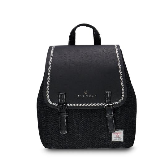 A black tweed backpack with a smooth leather top, featuring a dual-buckle design and a magnetic clasp.