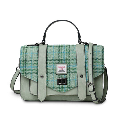 A brown satchel handbag with a plaid pattern on the front and a leather strap, featuring a structured silhouette.