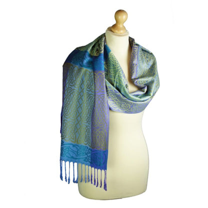 Blue and green patterned scarf on a mannequin with a white background