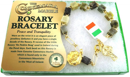 Rosary bracelet with gold accents and a flag charm on a Connemara Marble display card.