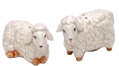 Two ceramic sheep figurines on a white background