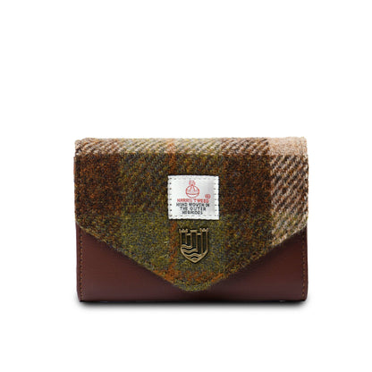 A small clasp purse with Harris Tweed and PU leather, featuring a metal popper fastening and a label showing the brand name.