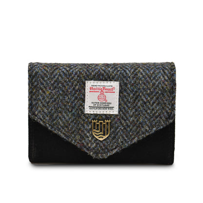A black small clasp purse with Harris Tweed and PU leather, featuring a metal popper fastening and a label showing the brand name.