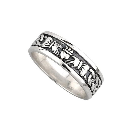 A sterling silver Claddagh band ring with a deep-set oxidized middle. The raised silver design on top is traditional claddagh artwork with a weaved sleeve design.