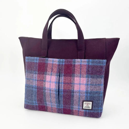 Purple tote bag with plaid pocket on a white background