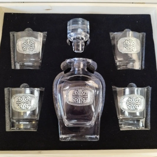 An elegant Mullingar Pewter decanter set displayed in a distressed wood-effect box, including a crystal decanter and four matching glasses, all adorned with pewter designs.